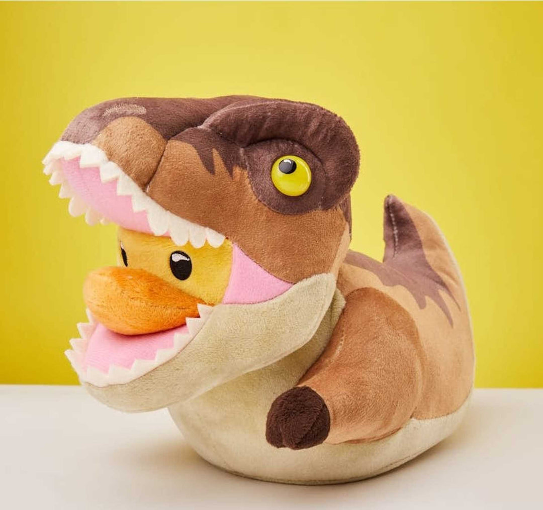 A cosplaying duck lush toy in a T-Rex costume